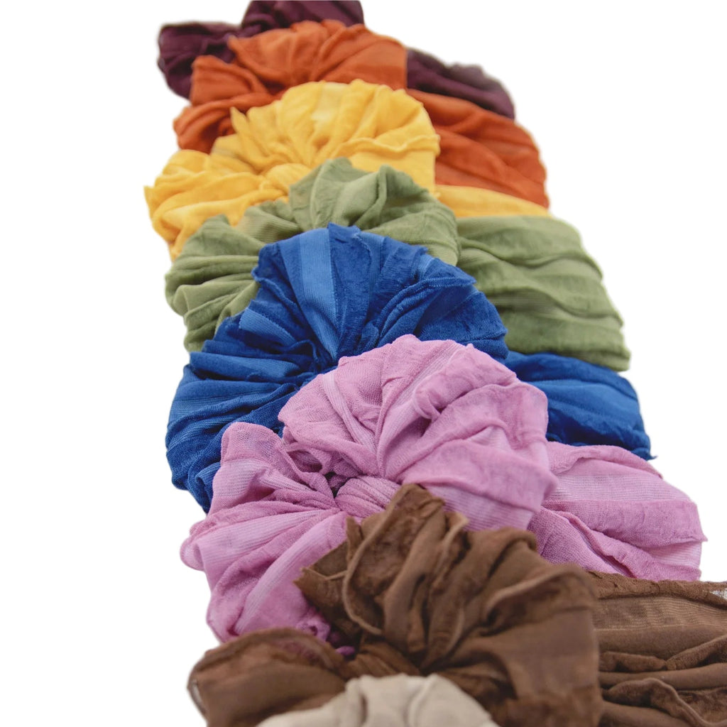 Colorful headbands arranged in a row on a white background